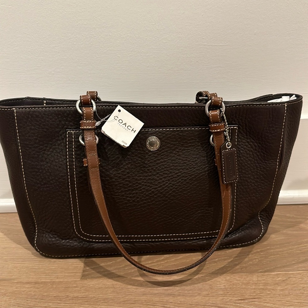 Brand new with tags. Classic Coach Brown leather tote with a purple lining.